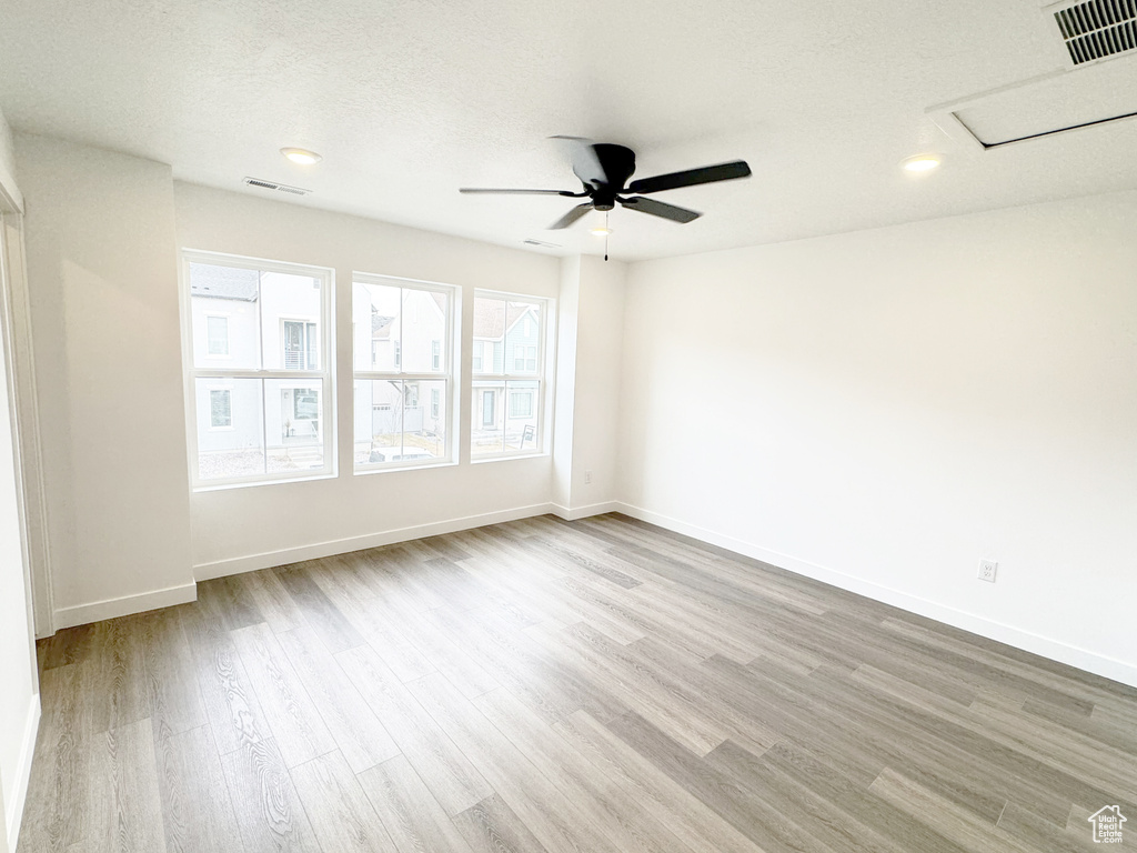 Unfurnished room featuring baseboards, visible vents, and wood finished floors