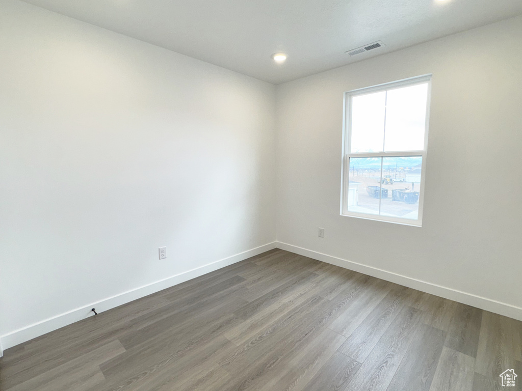 Spare room with baseboards, visible vents, recessed lighting, and wood finished floors