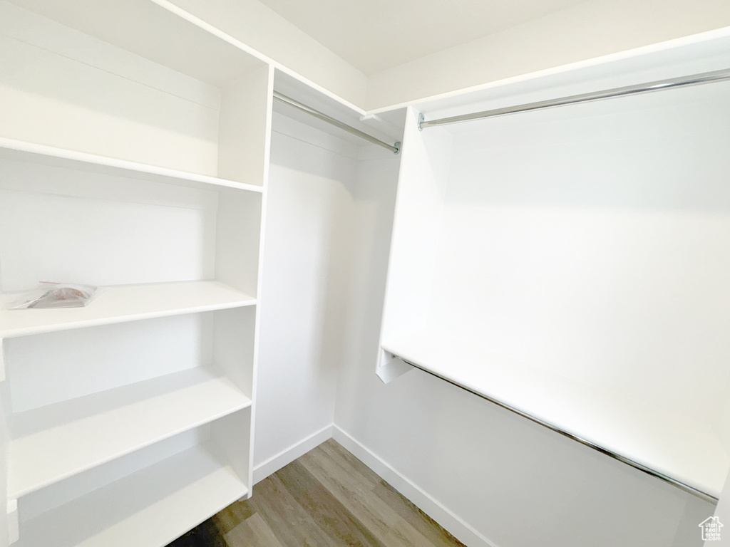 Walk in closet featuring wood finished floors