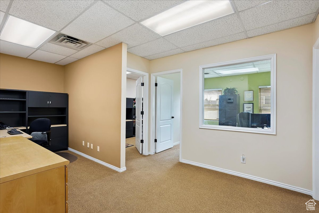 Carpeted home office featuring a paneled ceiling, baseboards, and visible vents