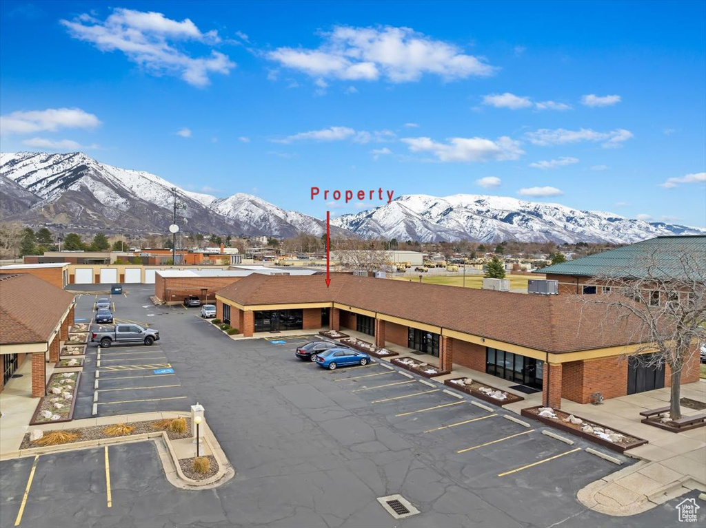 Uncovered parking lot featuring a mountain view
