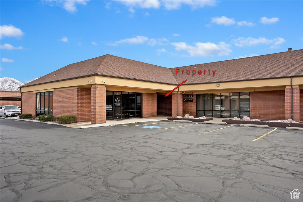 View of property featuring uncovered parking