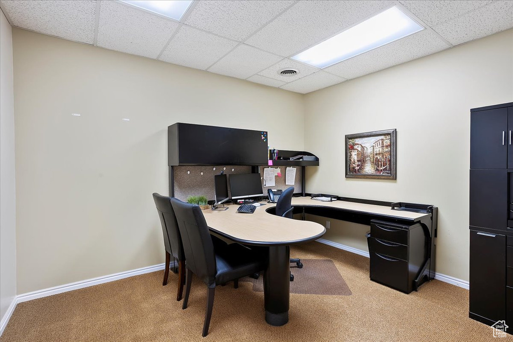 Office area with baseboards, visible vents, a paneled ceiling, and carpet
