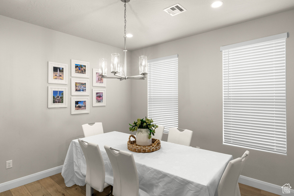 Dining space featuring a chandelier, baseboards, light wood-style floors, and recessed lighting
