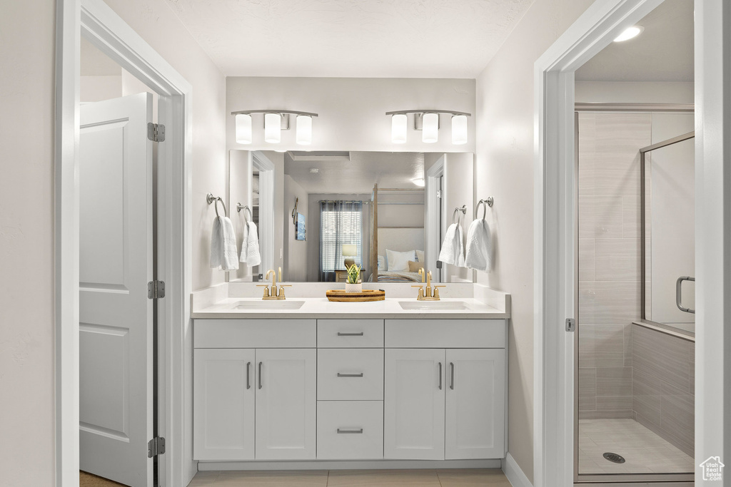 Ensuite bathroom with a stall shower and double vanity