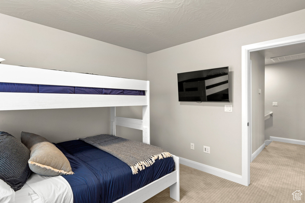 Carpeted bedroom featuring baseboards