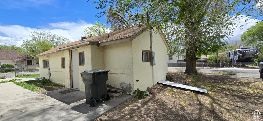 View of home\'s exterior with fence and stucco siding