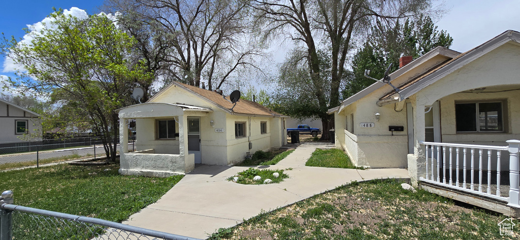 View of home\'s exterior featuring fence and stucco siding