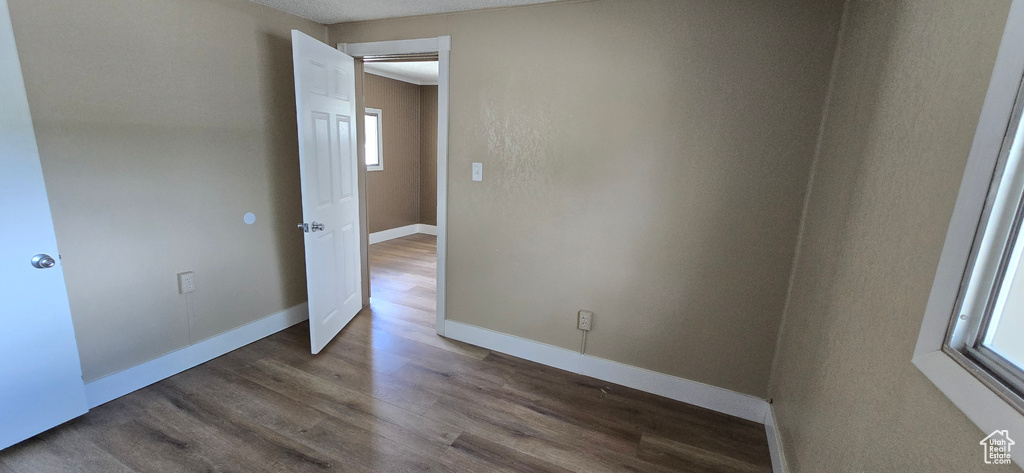 Empty room with wood finished floors and baseboards