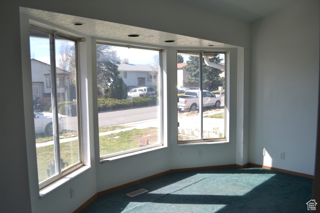 Unfurnished dining area with baseboards, a healthy amount of sunlight, and visible vents