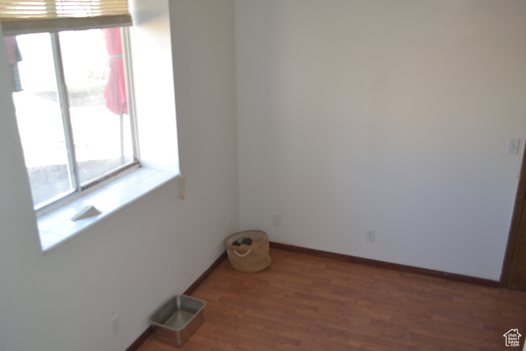 Empty room with baseboards and wood finished floors