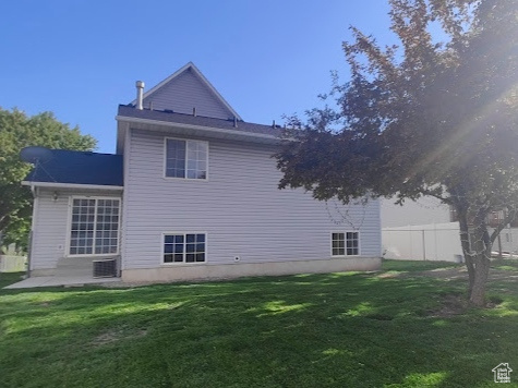 Back of house with a patio