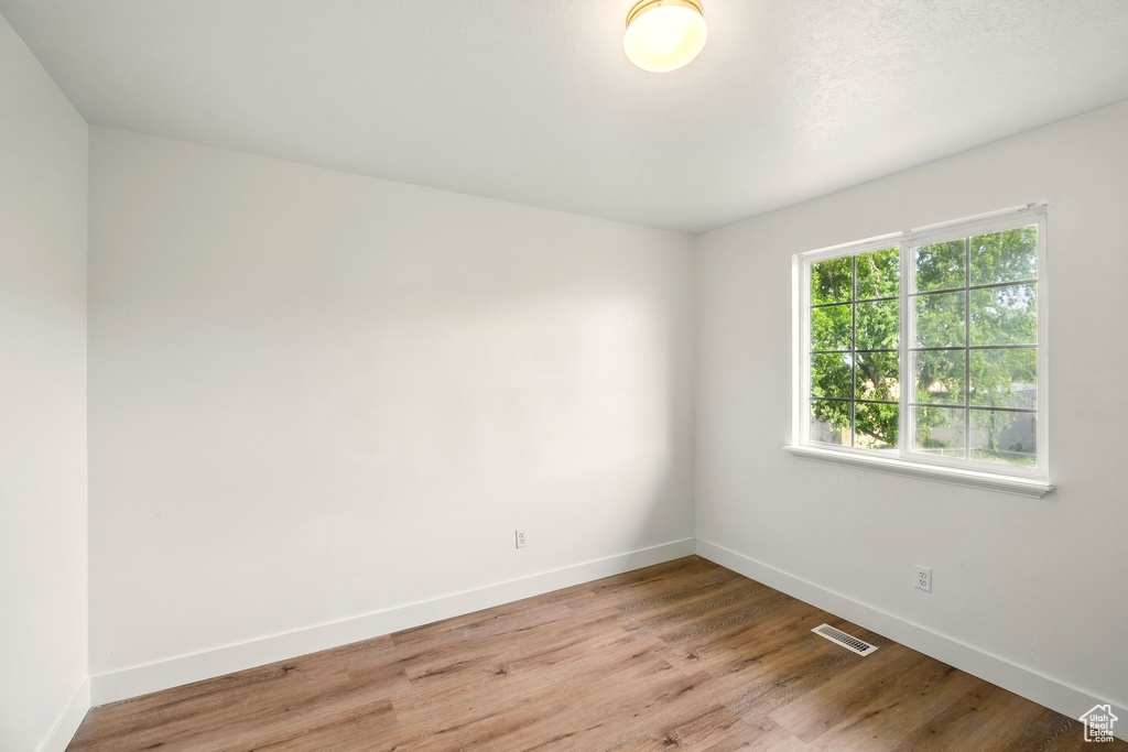 Empty room featuring baseboards and wood finished floors