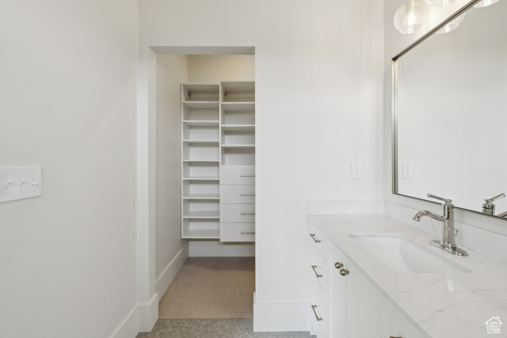 Bathroom featuring baseboards and vanity