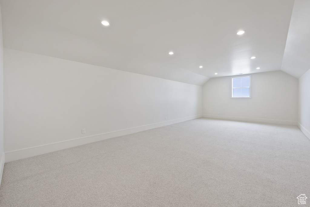 Bonus room featuring light carpet, baseboards, lofted ceiling, and recessed lighting
