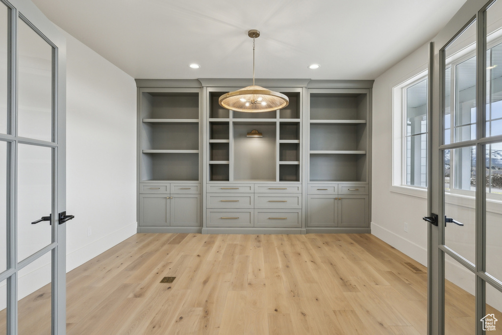 Unfurnished dining area with baseboards, french doors, recessed lighting, and light wood-type flooring