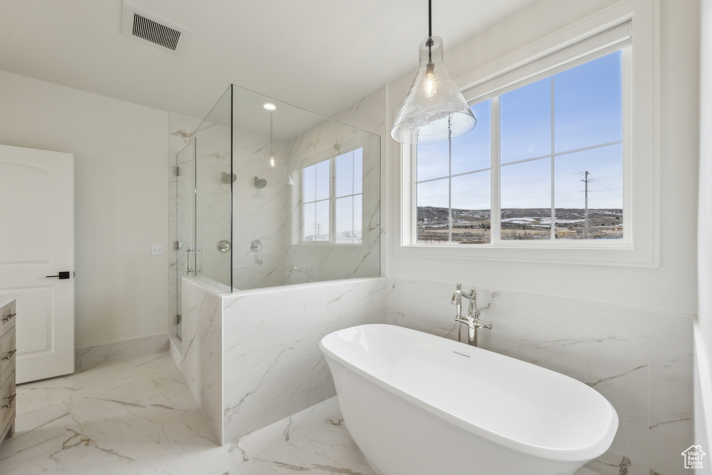 Bathroom featuring a marble finish shower, marble finish floor, visible vents, a freestanding bath, and recessed lighting