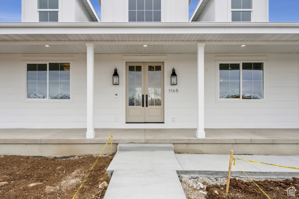 Entrance to property with a porch and board and batten siding