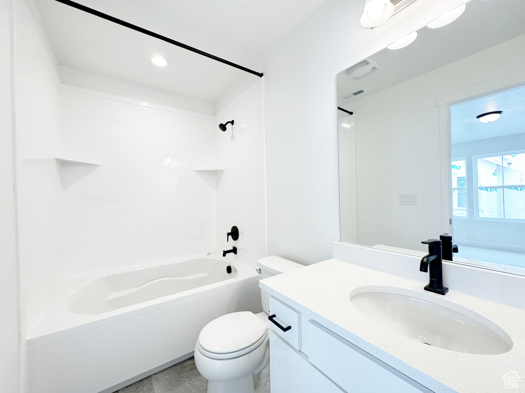 Bathroom with toilet, vanity, washtub / shower combination, and visible vents