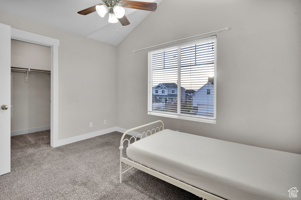 Bedroom with carpet flooring, ceiling fan, vaulted ceiling, and a closet