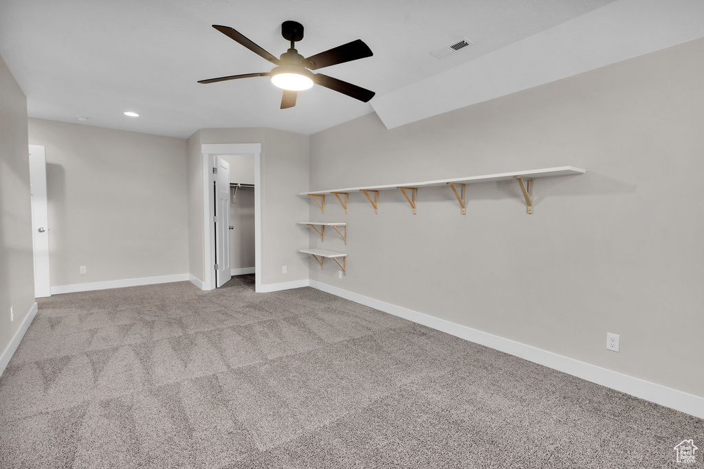 Empty room with light colored carpet and ceiling fan