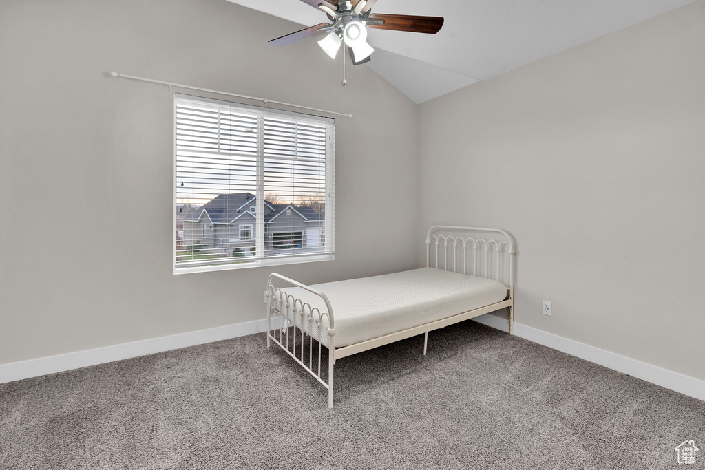 Bedroom with carpet flooring, ceiling fan, and lofted ceiling