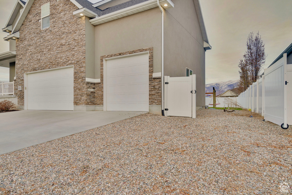 View of property exterior featuring a garage