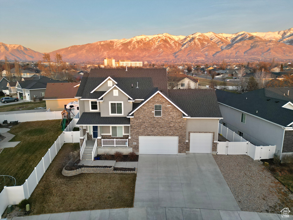 View of front facade featuring a mountain view, covered porch, and a yard