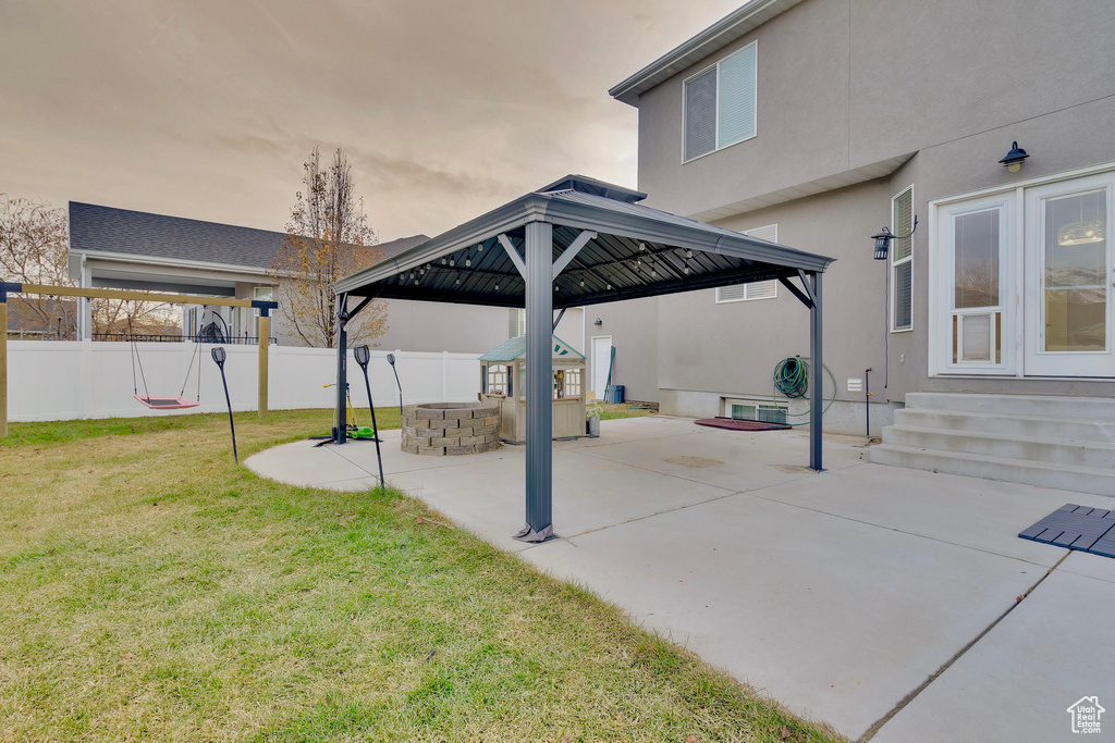 View of patio featuring a gazebo and a fire pit