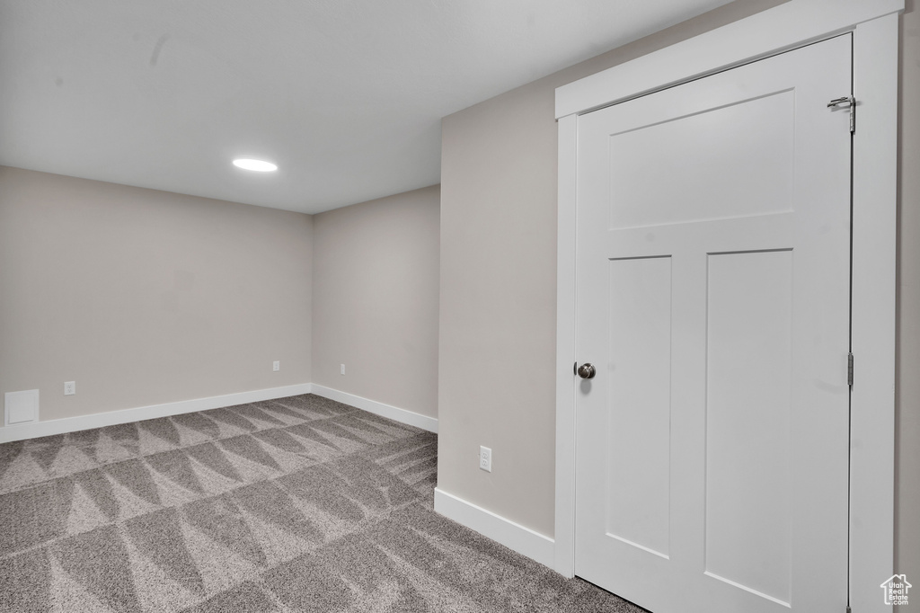 Unfurnished room with light carpet