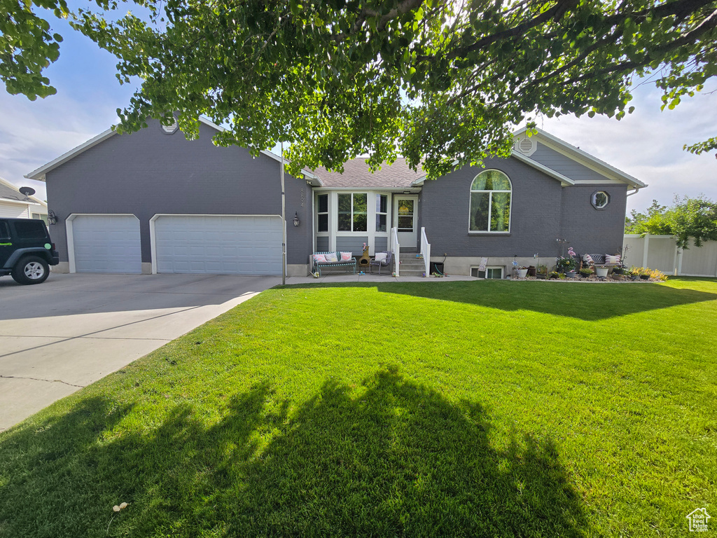 Ranch-style house featuring an attached garage and concrete driveway