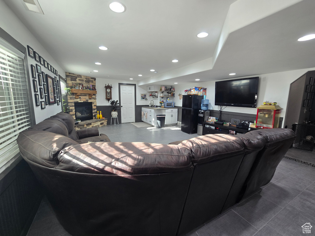 Living room with bar area, a fireplace, visible vents, and recessed lighting