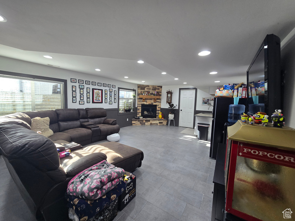 Living room featuring a stone fireplace and recessed lighting