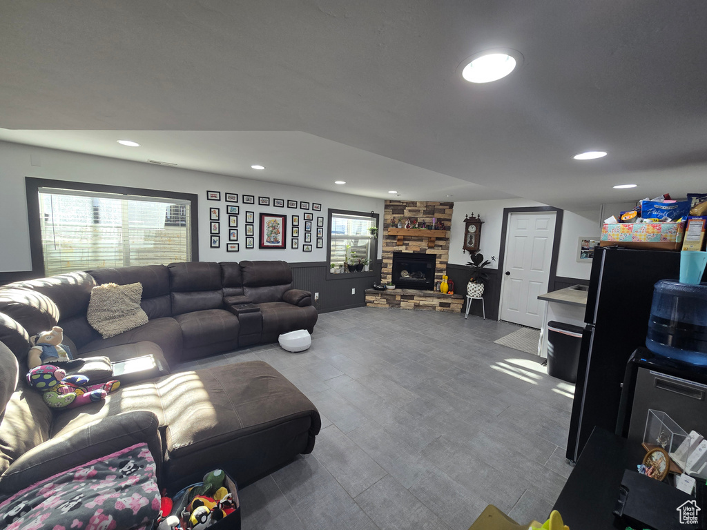 Living room with a stone fireplace and recessed lighting