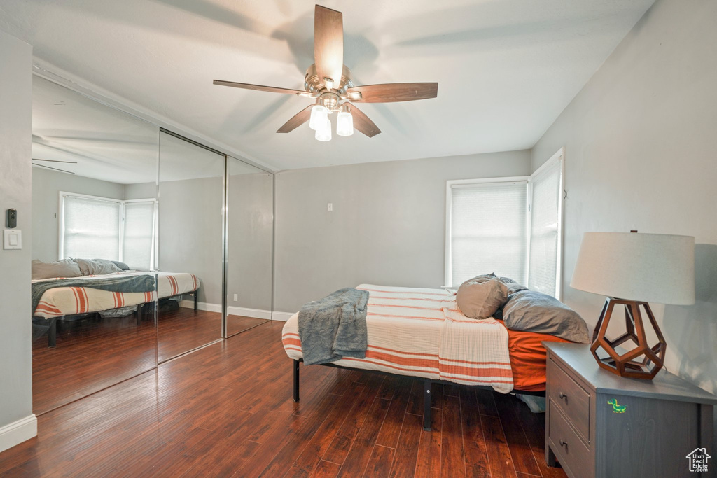 Bedroom with ceiling fan, a closet, baseboards, and wood finished floors