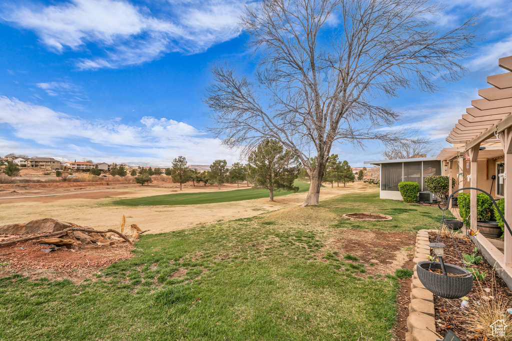 View of yard with a sunroom and central AC