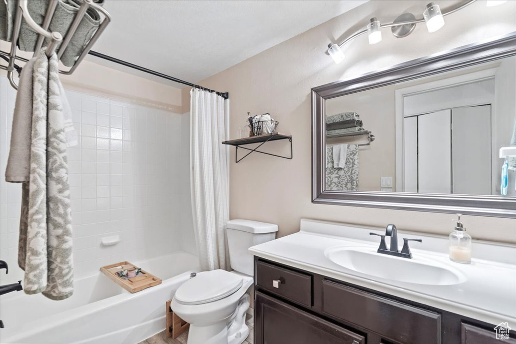 Full bath with shower / bath combo, toilet, and vanity