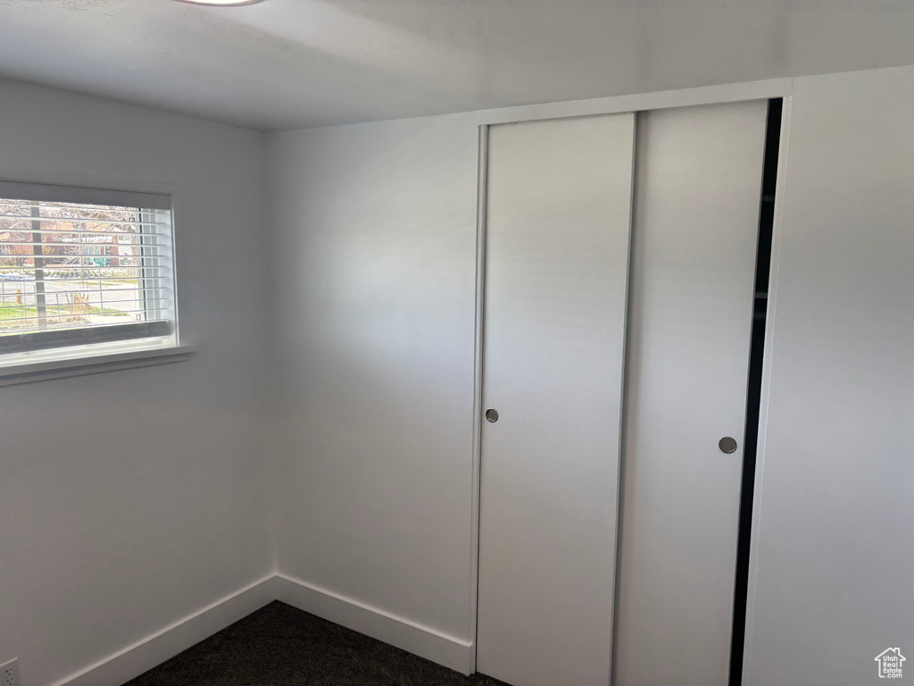 Unfurnished bedroom with a closet and baseboards