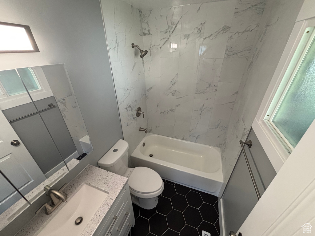 Full bath featuring toilet, vanity, and washtub / shower combination