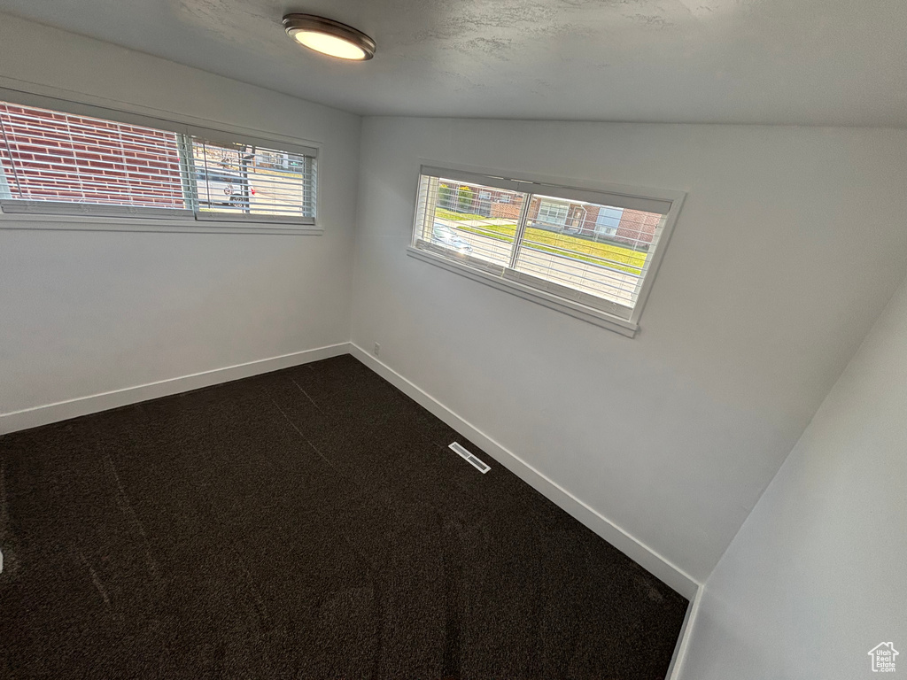 Unfurnished room featuring baseboards and visible vents