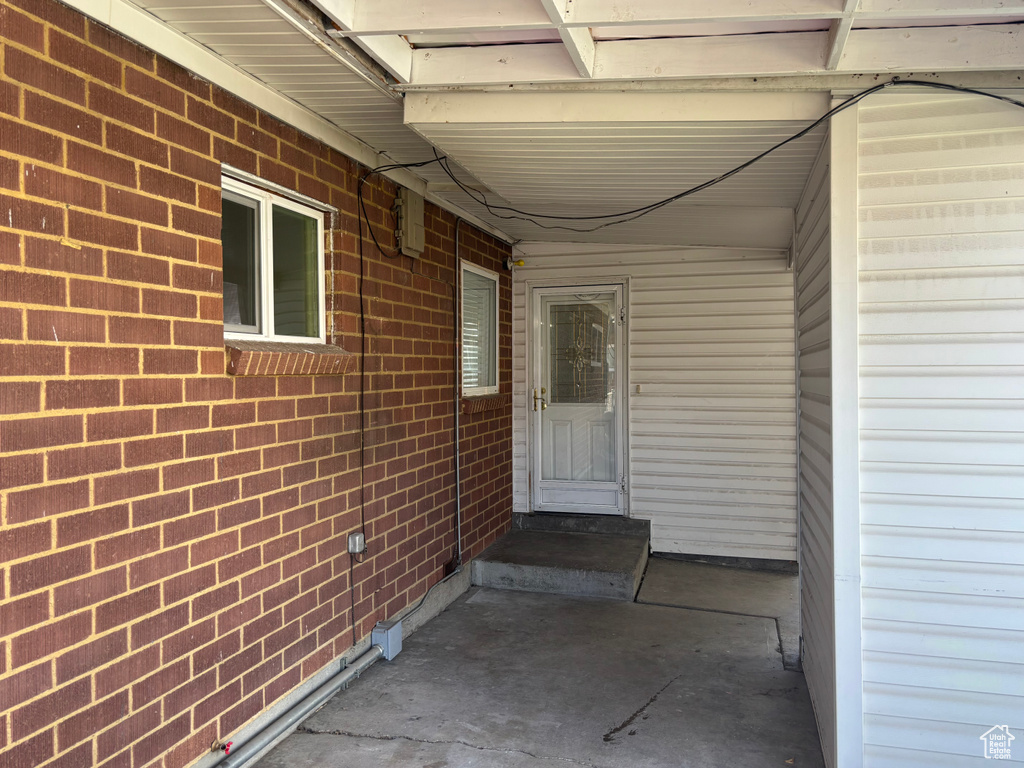 View of exterior entry featuring brick siding