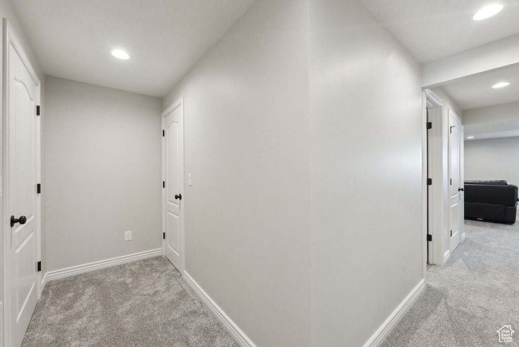 Hall featuring carpet floors, baseboards, and recessed lighting