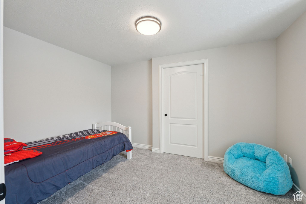 Carpeted bedroom with baseboards