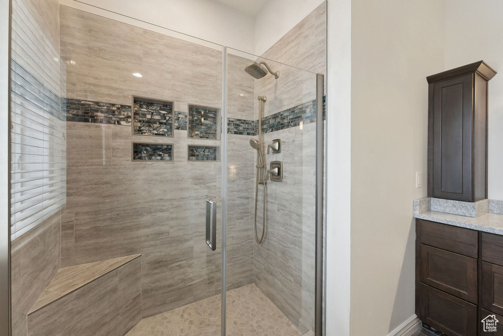 Full bath with vanity and a shower stall