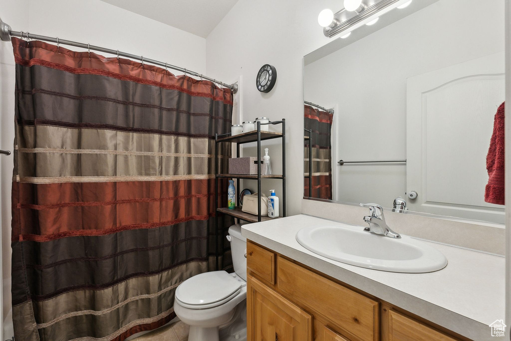 Bathroom with a shower with shower curtain, toilet, and vanity