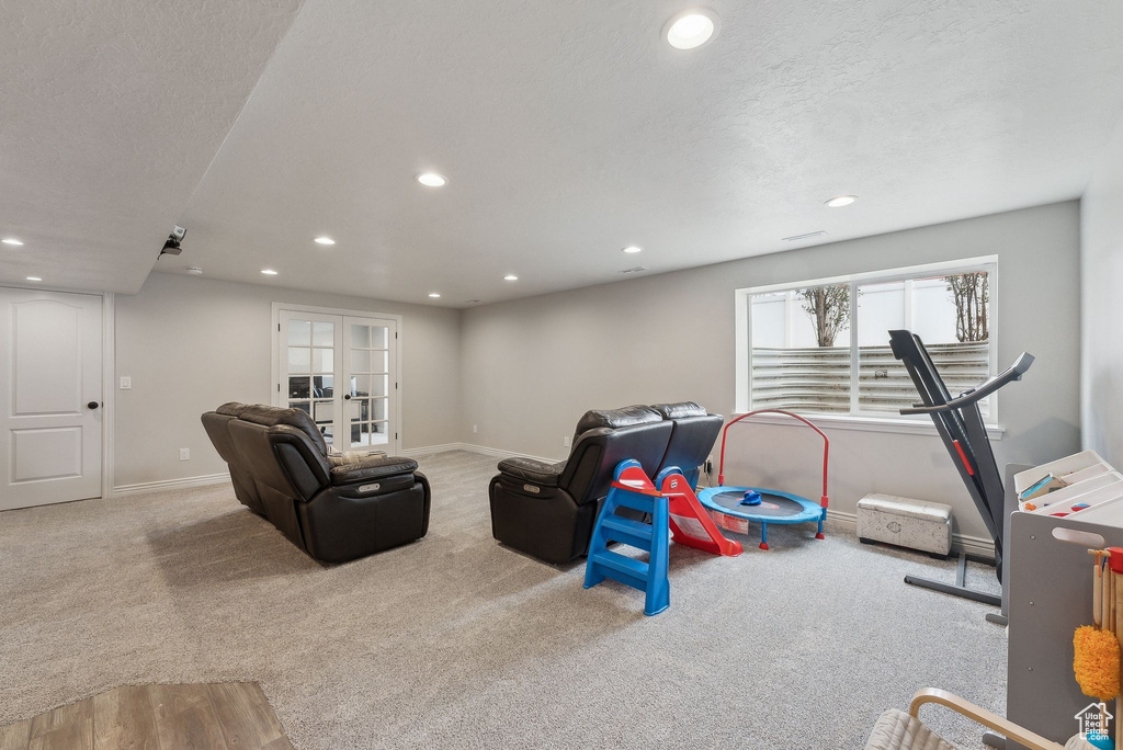 Living room with baseboards, recessed lighting, carpet, and a textured ceiling