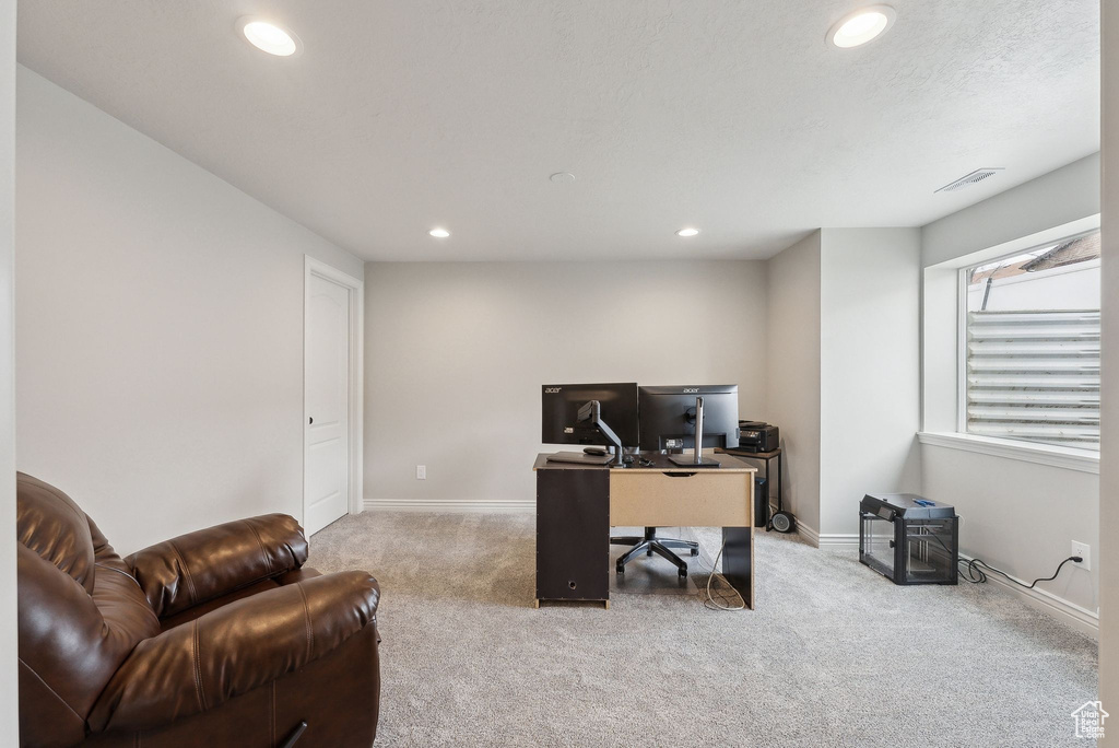 Carpeted home office featuring visible vents, baseboards, and recessed lighting