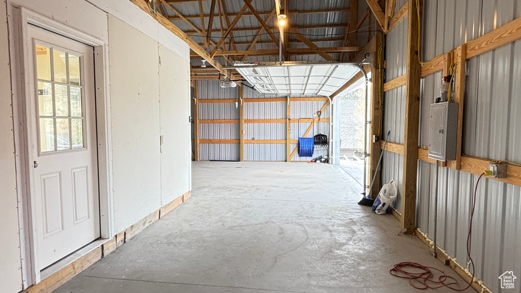 Misc room featuring electric panel and a garage