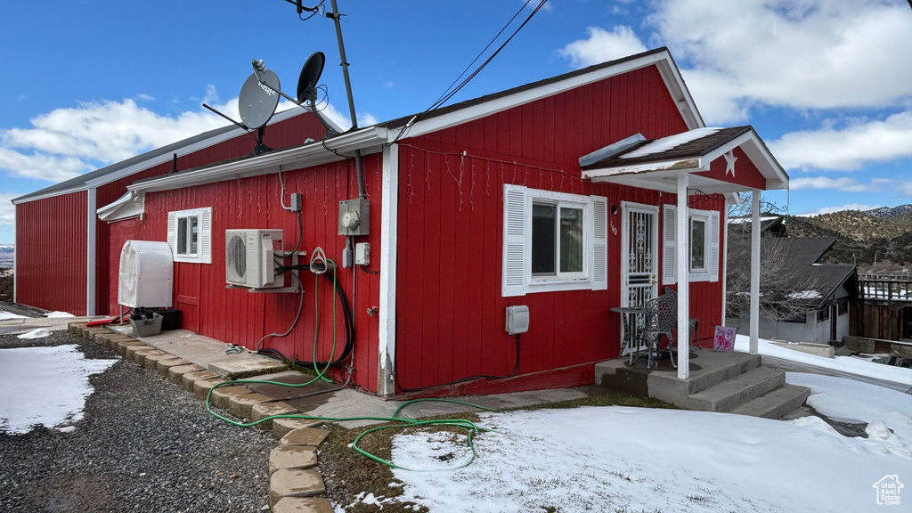 View of snowy exterior featuring ac unit