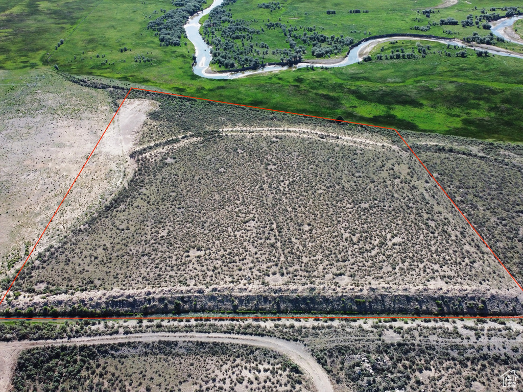Aerial view of sparsely populated area with property parcel outlined
